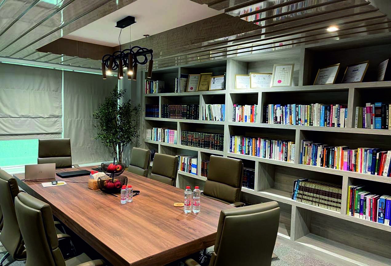 Boardroom designed by ICD with a timber table and library wall